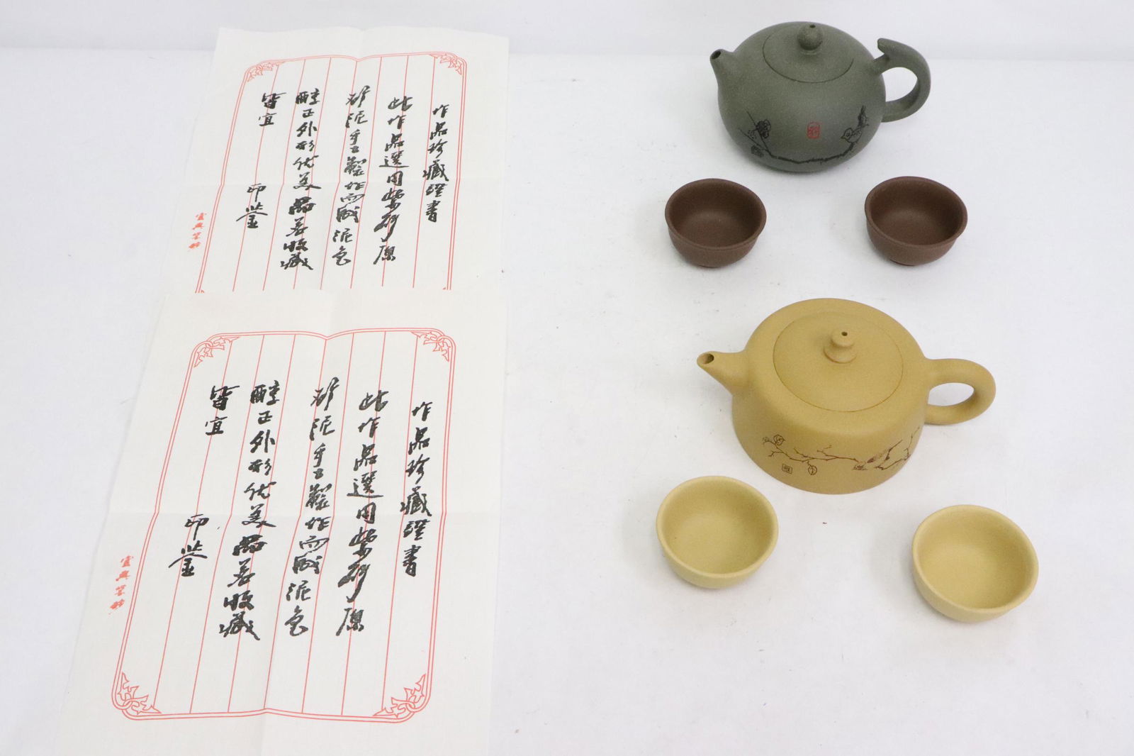 2 Yixing tea set; each set has a teapot & 2 tea cups: 2 Yixing tea set; each set has a teapot (2.6"x6"x3.7", 3.2"x5.2"x3.7") and 2 tea cups (1.1"x2.2"dia)