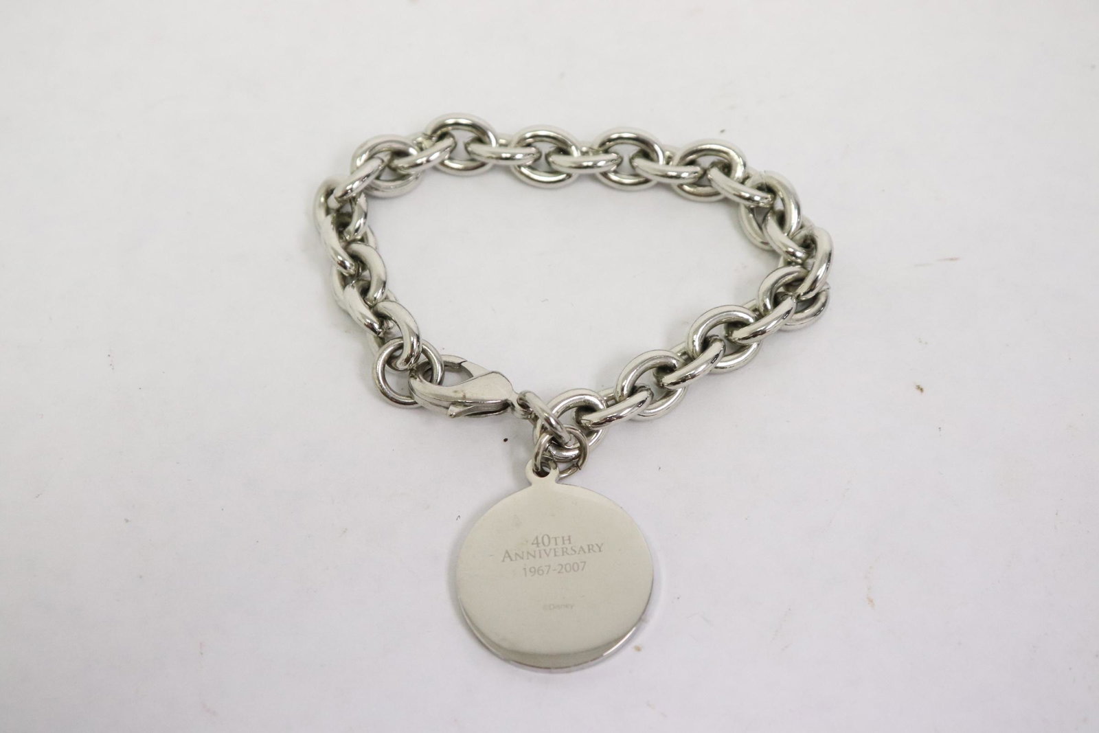Disneyland 2007 charm bracelet: Disneyland 2007 charm bracelet with one charm engraved with club 33 logo, dated 1967-2007, for 40th anniversary