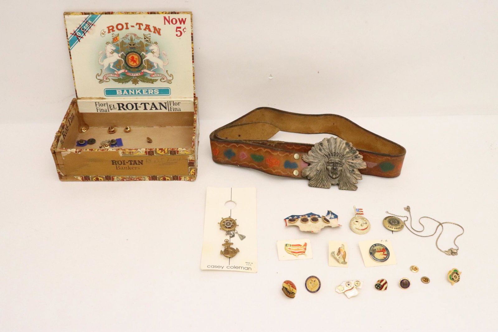 Lot of pins, and a leather belt w/ Indian motif belt buckle: Lot of pins, and a leather belt with Indian motif belt buckle (3.4"x4.2")