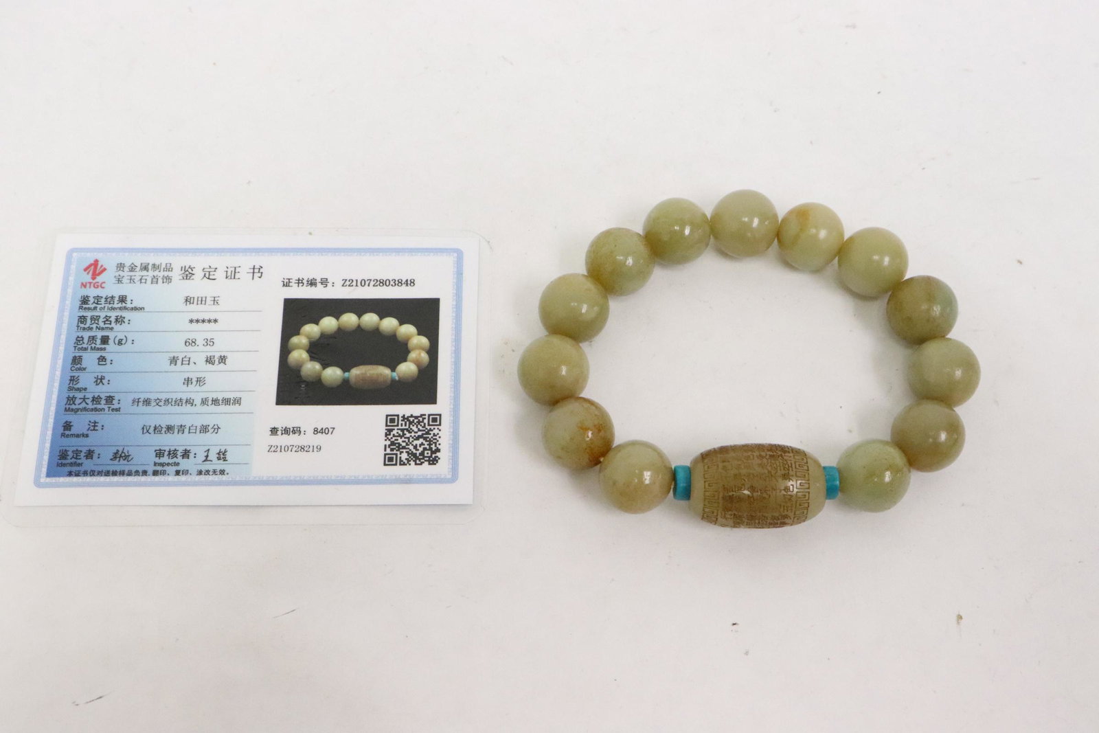 A jade bead bracelet: A jade bead (0.5"dia - 0.9"x0.65"dia) bracelet