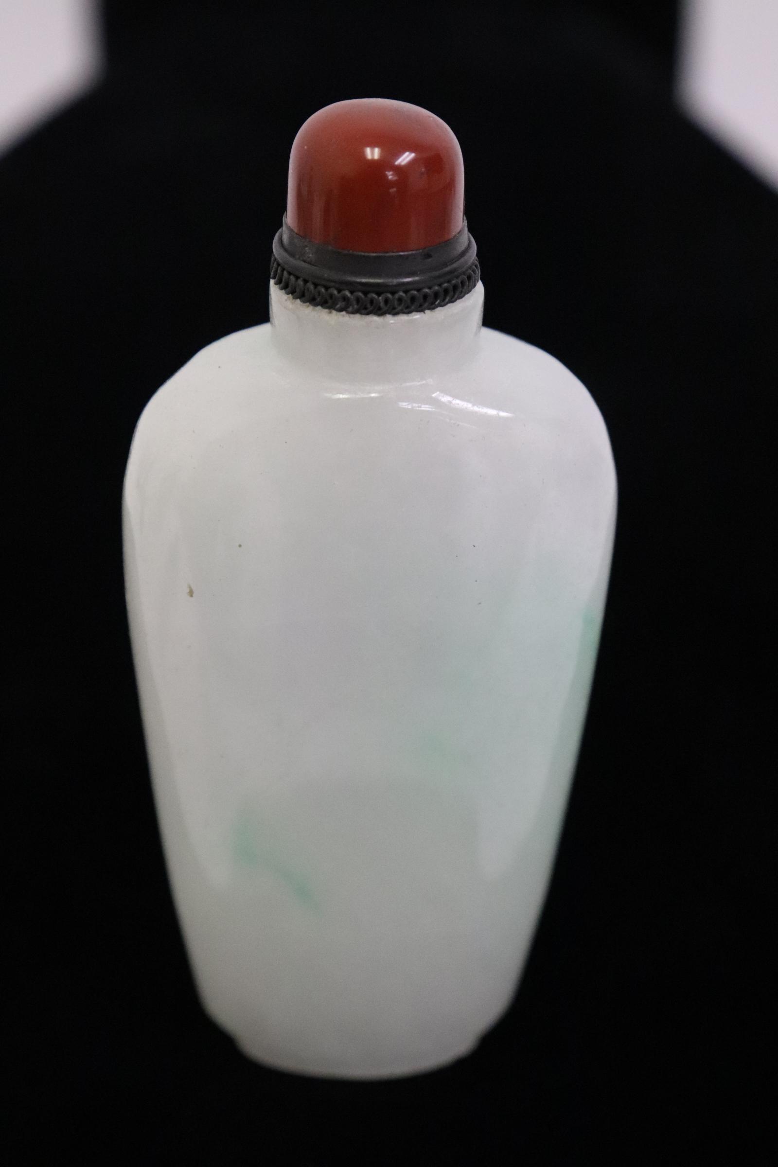 A fine light apple green jadeite carved snuff bottle (1 of 8)