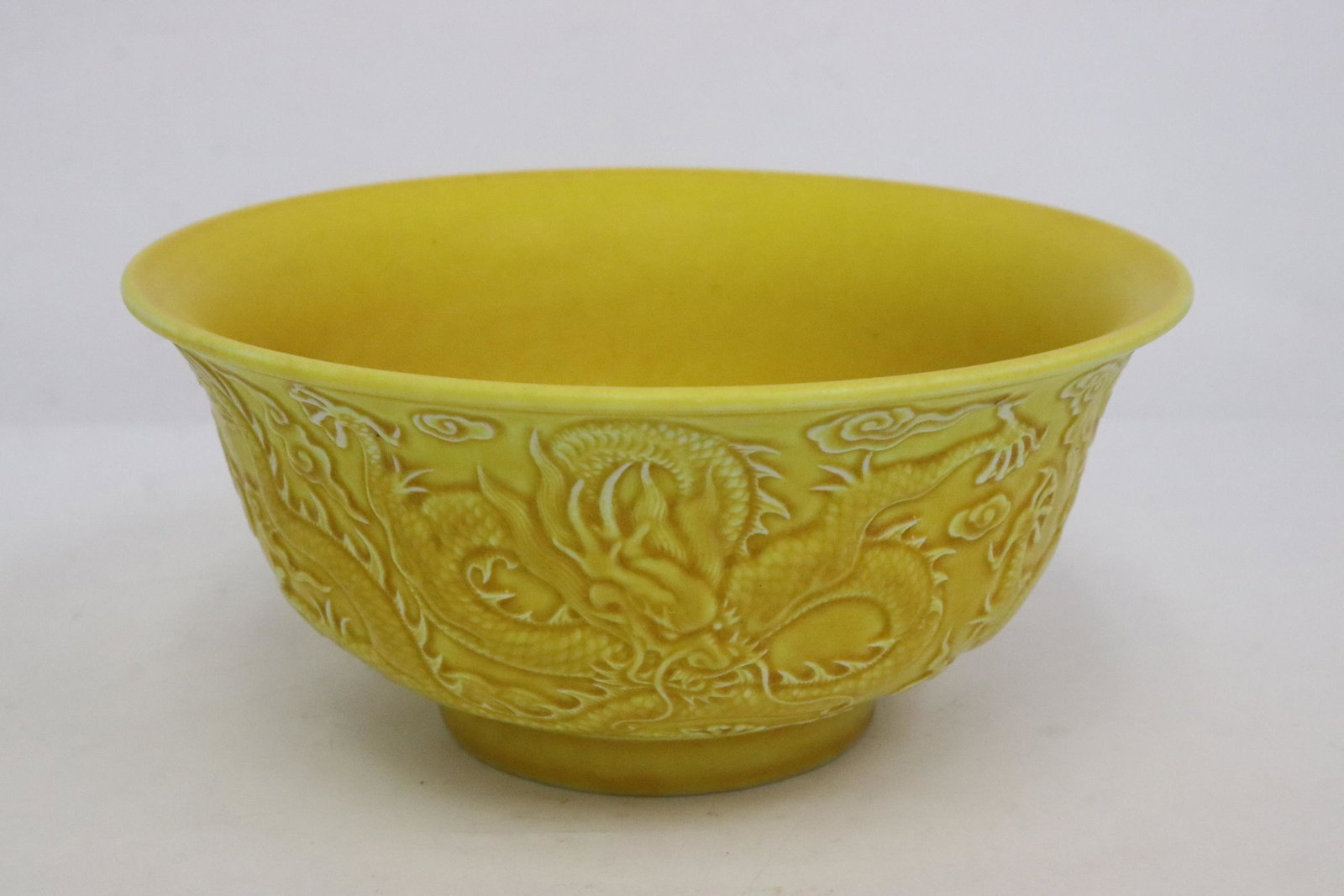 Chinese yellow glazed bowl: Chinese yellow glazed bowl embossed with dragon motif decoration, 2.9"x6.1"dia