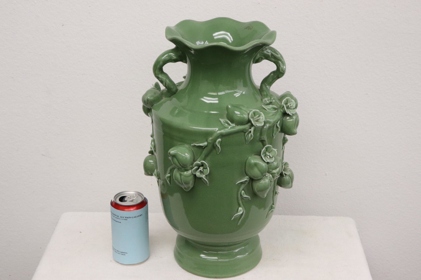 A celadon Chinese porcelain vase: A celadon Chinese porcelain vase with decoration in high relief, 16.8"x10.6"x10.6"