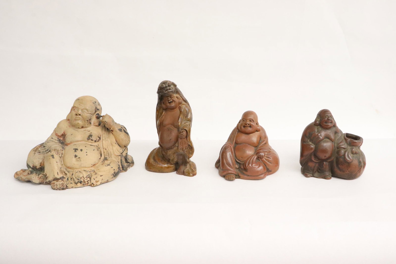 4 Japanese 19th/20th century earthenware deities: 4 Japanese 19th/20th century earthenware deities, 3.7"H - 5.9"H