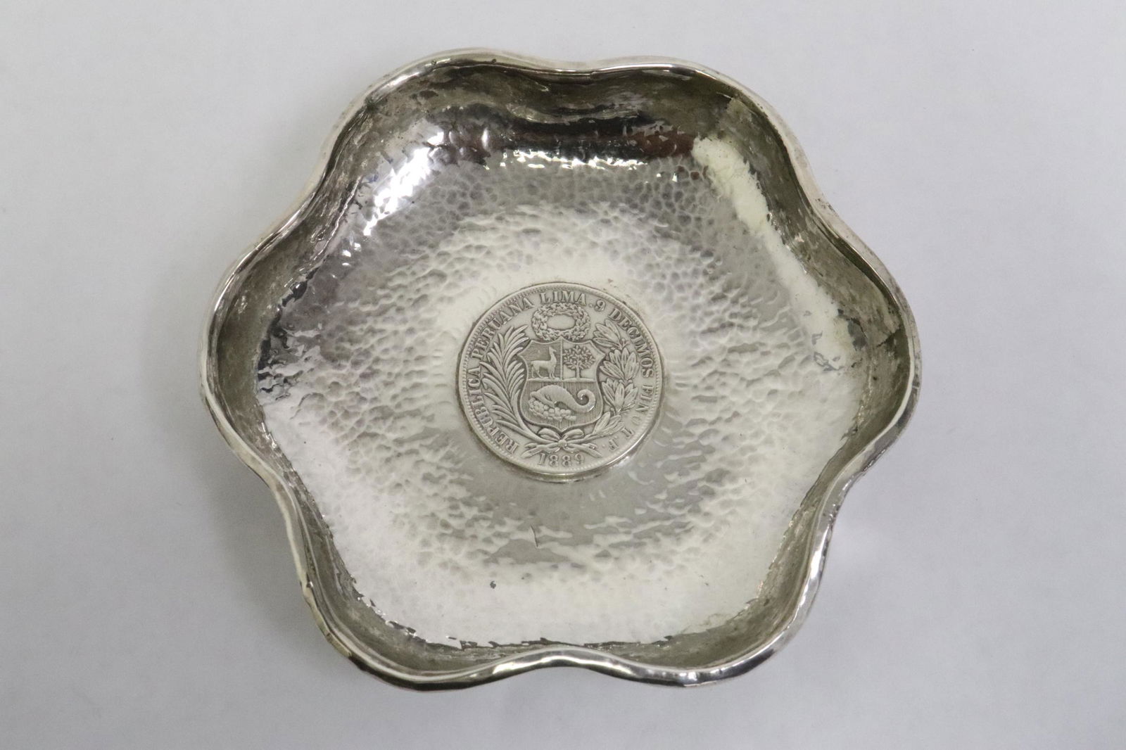 A hand hammered sterling plate w/ silver coin (1 of 10)