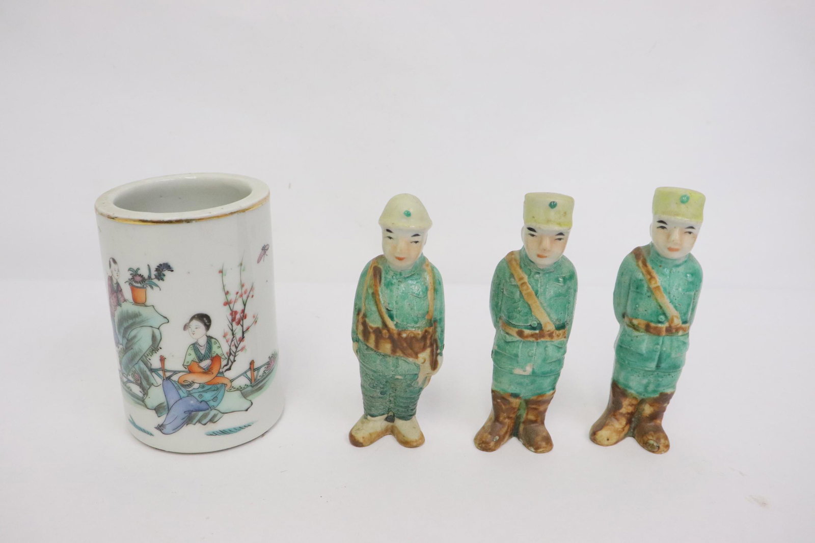 4 pieces: 4 pieces; Chinese antique famille rose porcelain brush holder (4.15"x2.8"dia), and 3 unusual early 20th century Chinese porcelain figures in military uniform (4.4"H, 4.5"H(2))