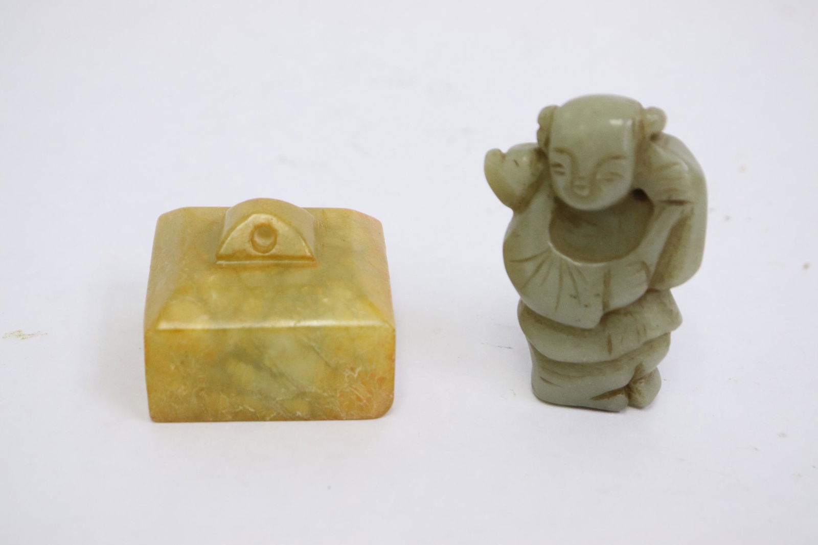 Jade seal and a celadon jade figure: Jade seal (1.2"x1.6"x1.6") and a celadon jade figure (2.1"H)