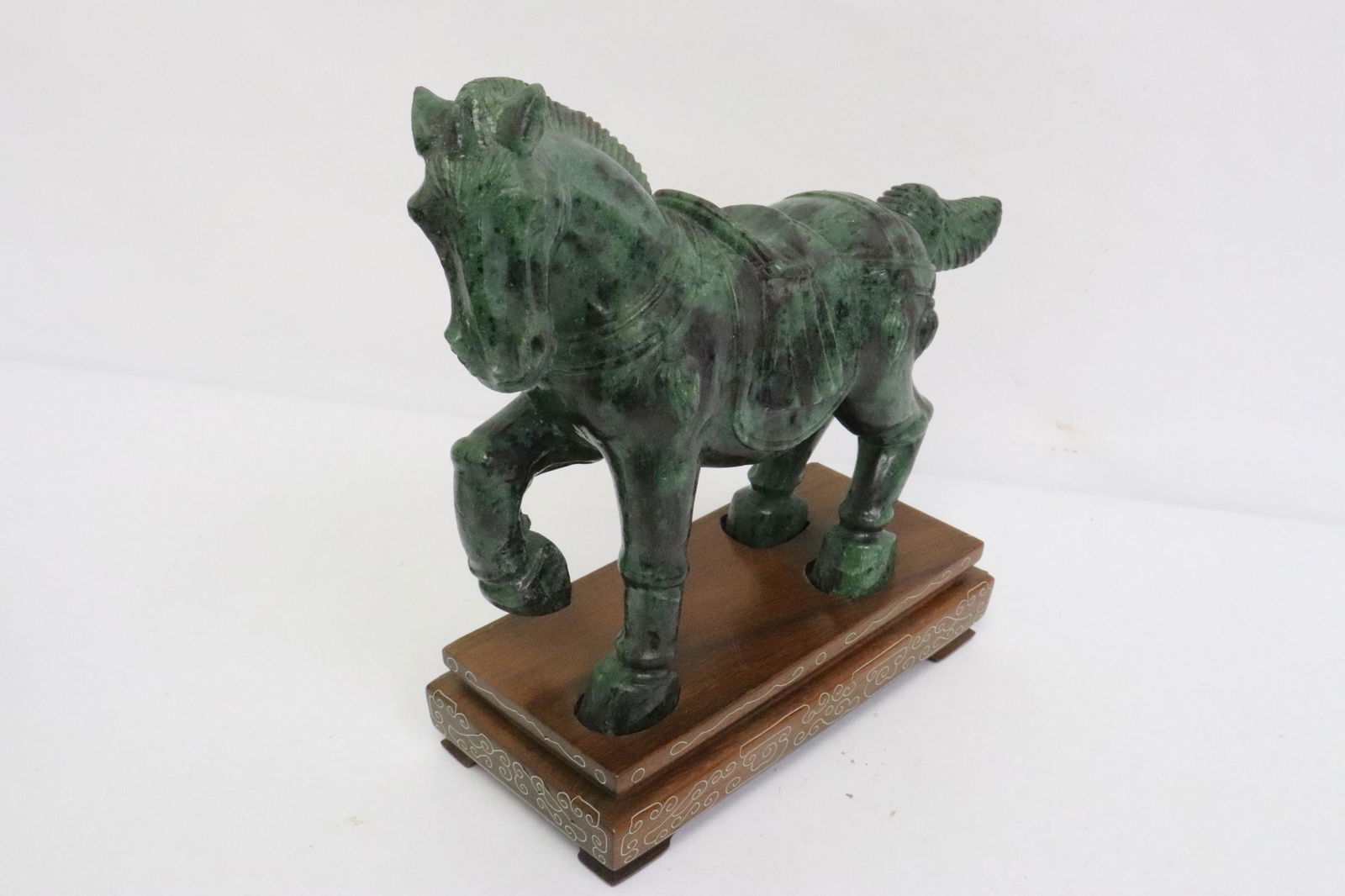 A green jade like stone carved horse: A green jade like stone carved horse, one leg has hairline, 8"H