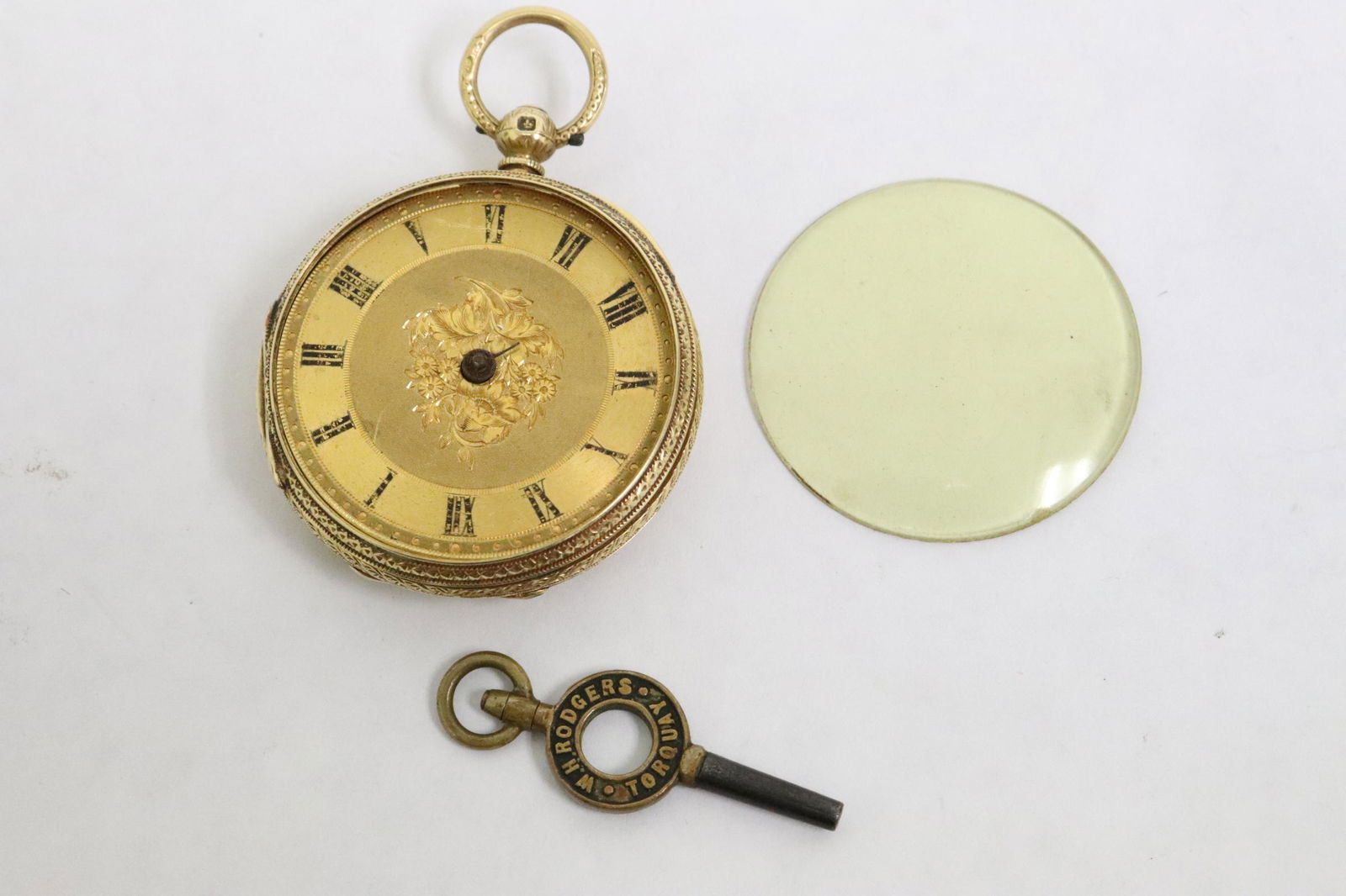 antique 18K rose gold pocket watch with key: A fine English antique 18K rose gold pocket watch (1.75"dia) with key, wt. 19.6gm (without crystal, mechanism and key), dust cover also marked 18K, missing both hour and minute hands, crystal loose