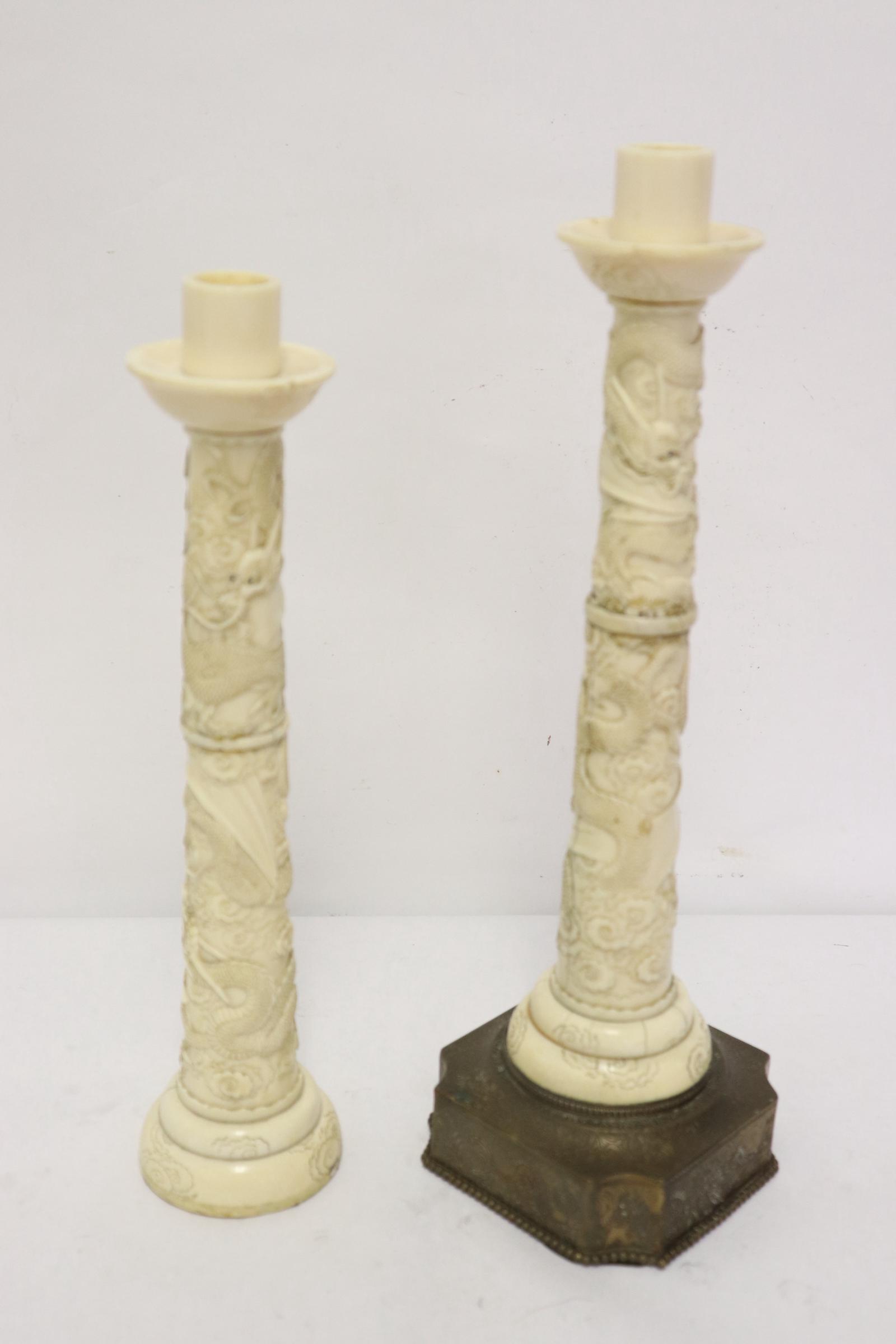 2 Chinese antique bone carved candle holders: 2 Chinese antique bone carved candle holders with dragon motif decoration in high relief (11.25"x3.5"x3.5"), one missing base (9.9"x2.25"dia), hairlines