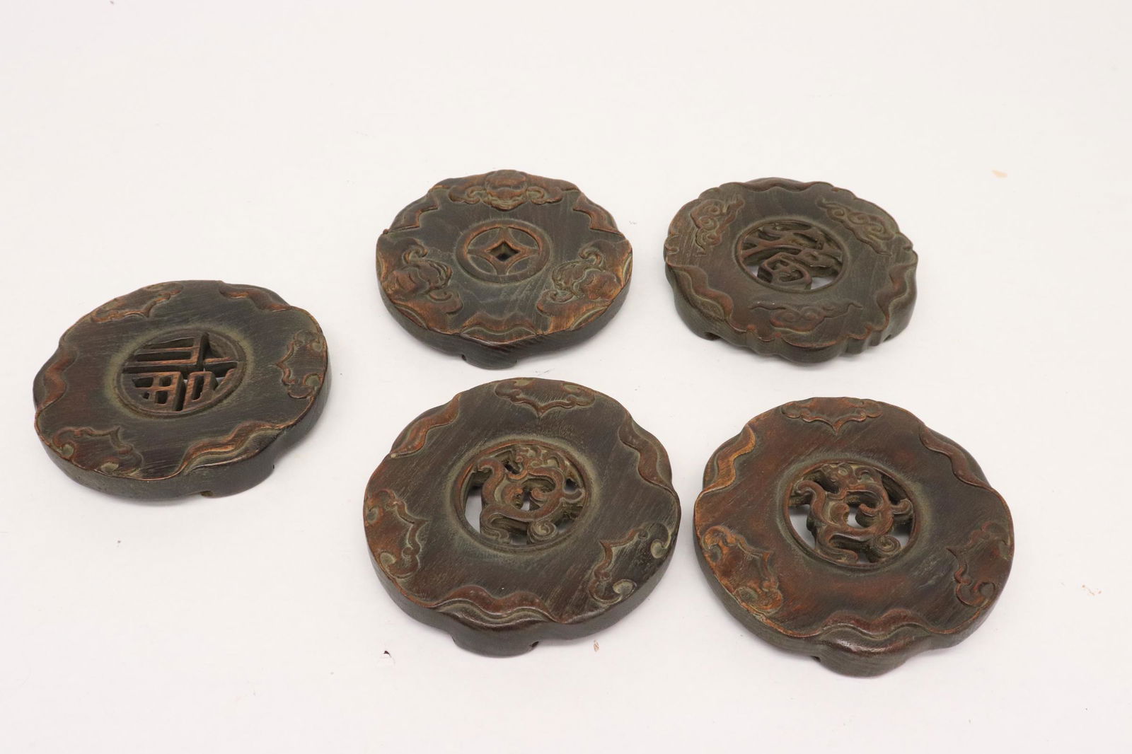 5 Chinese wood carved stands/ coasters: 5 Chinese wood carved stands/ coasters, 1"x5.5"dia