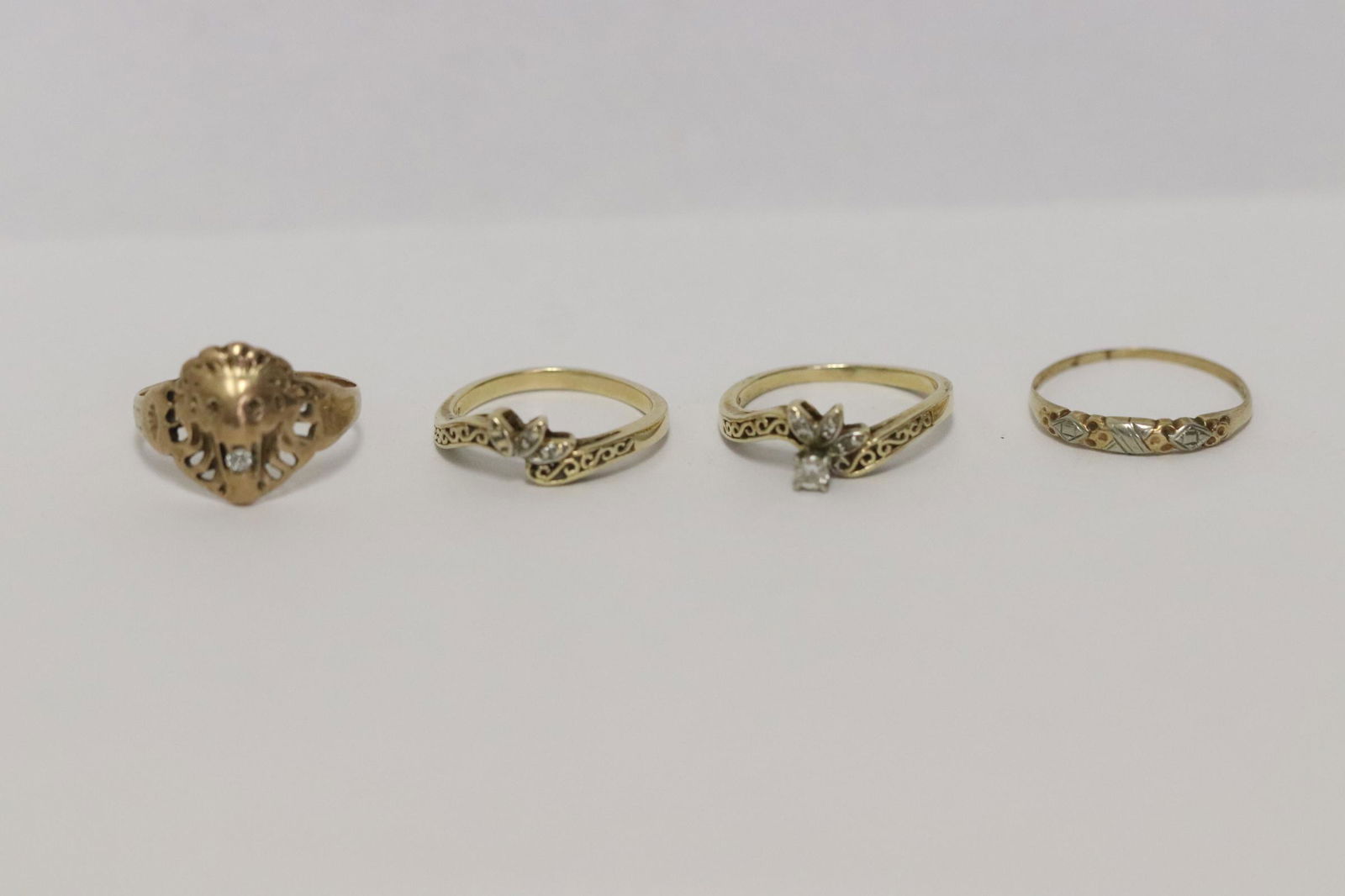 Four 10K Y/G rings set with small diamonds (1 of 11)