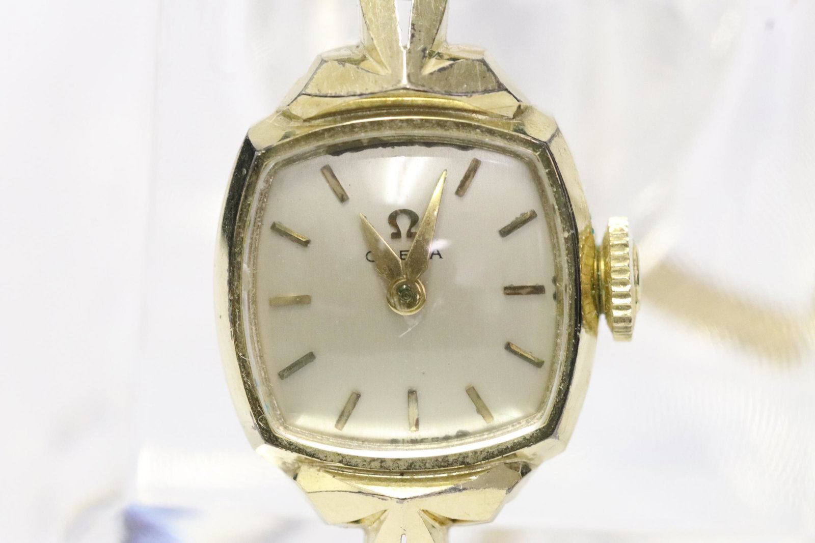 14K lady's Omega wrist watch w/ a solid 14K band: A 14K Y/G lady's Omega wrist watch attached to a solid 14K Y/G band, wt. 15.2gm