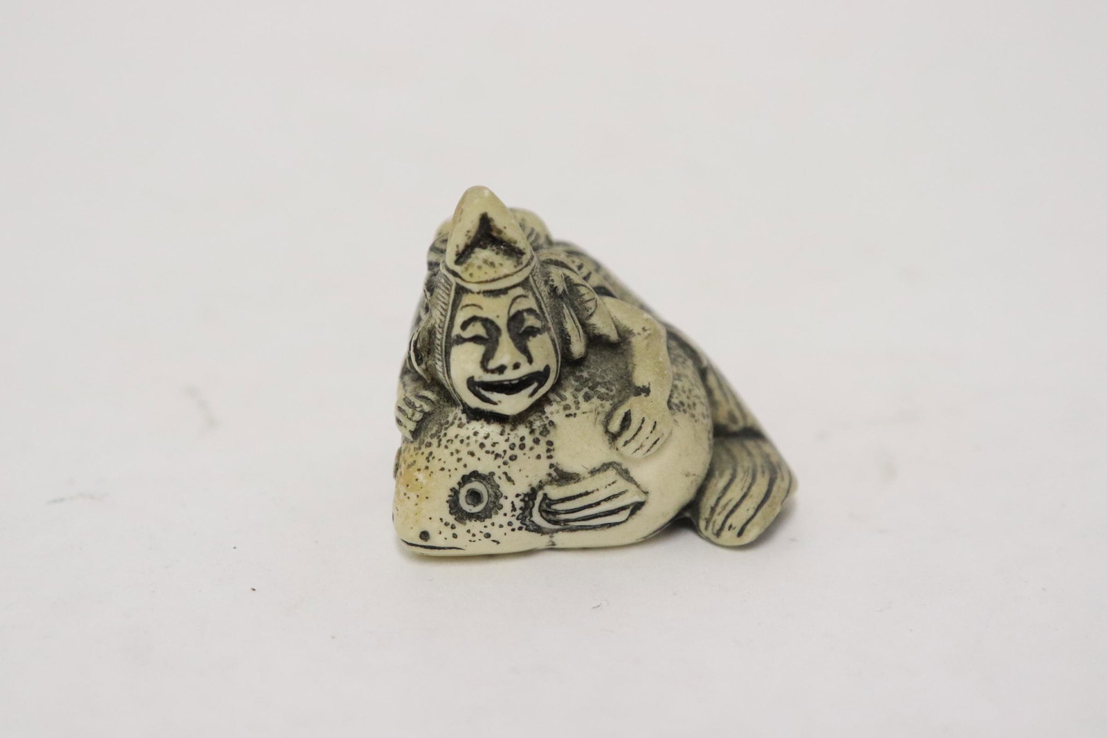 Japanese vintage bone carved netsuke: Japanese vintage bone carved netsuke depicting man holding a fish, 1.2"x1.5"x1.13"