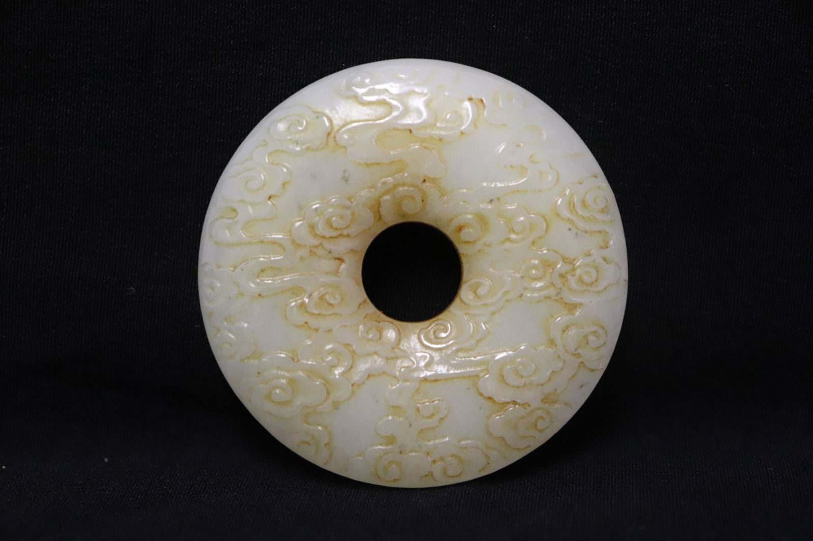 A white jade like stone carved disc (1 of 10)
