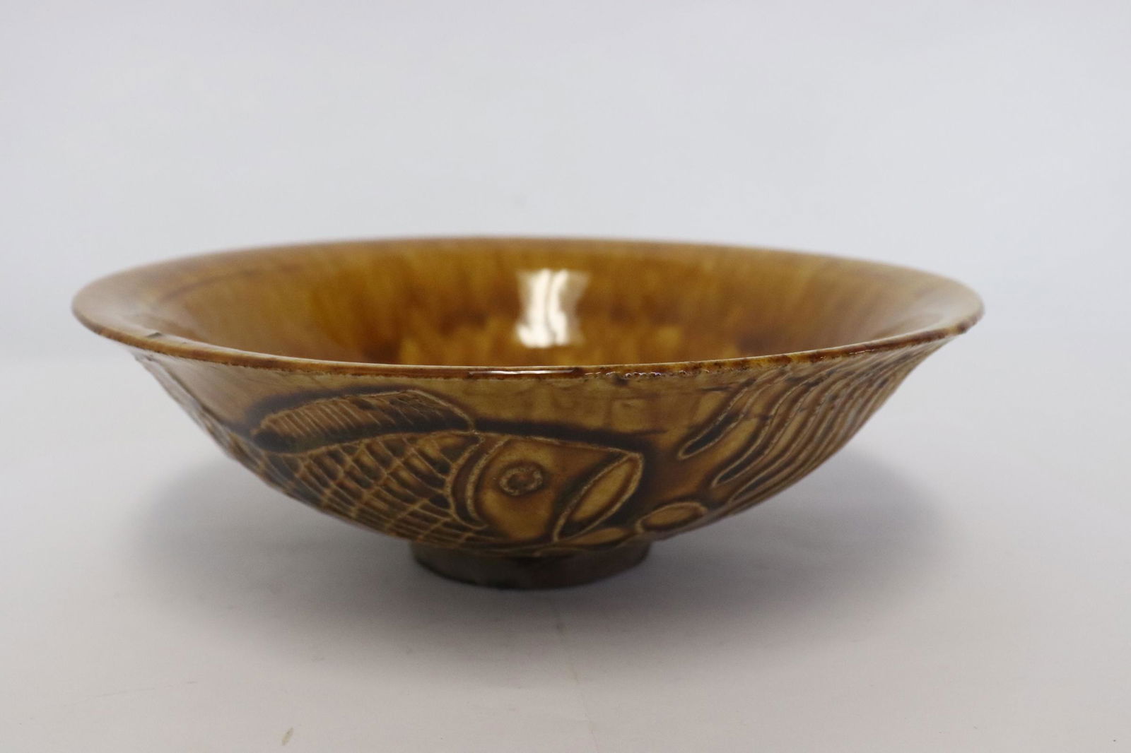A brown glazed earthenware bowl (1 of 10)
