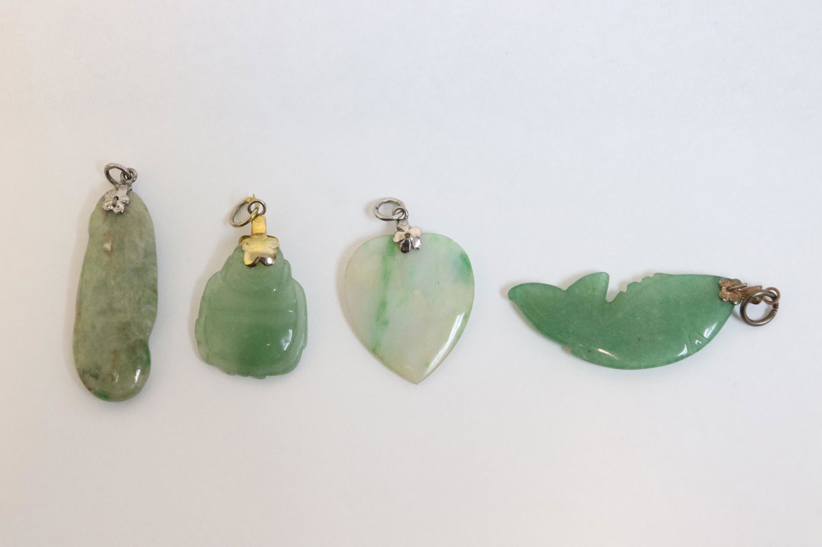 4 vintage jadeite carvings made as pendants: 4 vintage jadeite carvings made as pendants, 0.95"x0.75"x0.13" - 1.5"x0.63"x0.13"