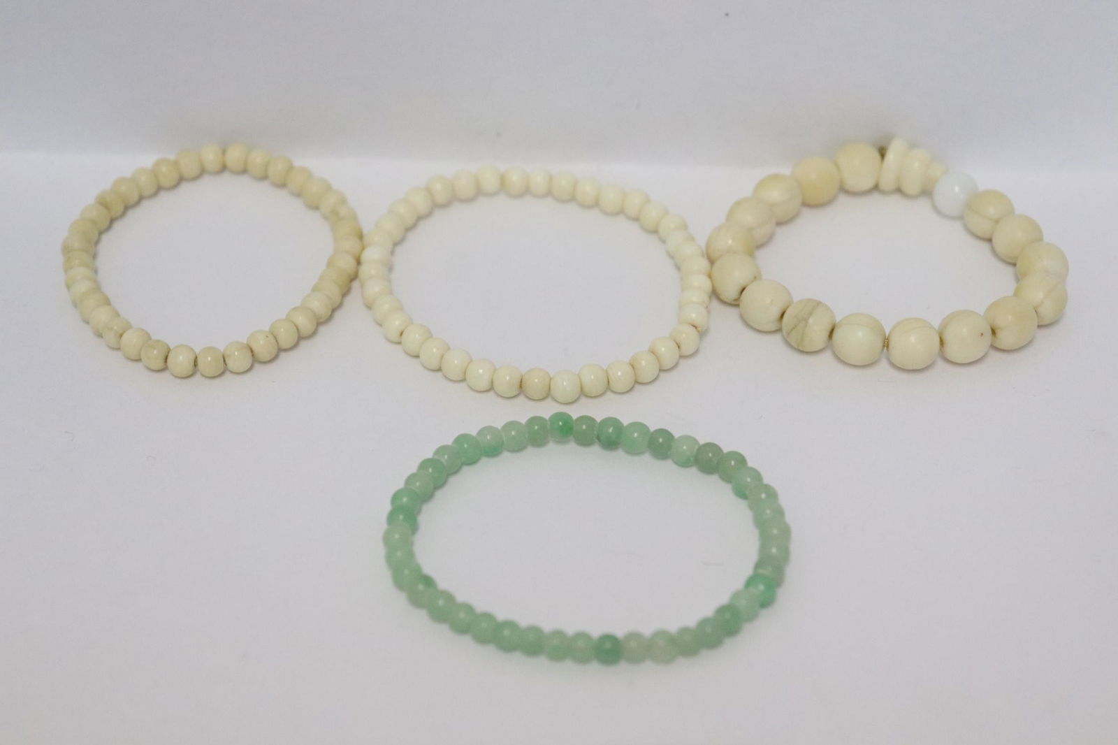 3 bone carved bracelets, & a jadeite bead bracelet: 3 Chinese bone carved (0.2"dia - 0.35"dia) bracelets, and a jadeite bead (0.15"dia) bracelet