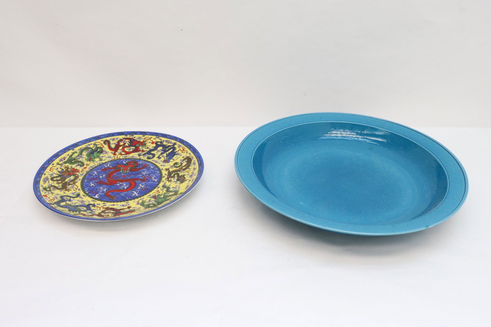 2 porcelain plates: 2 porcelain plate; a blue glazed charger (2.9"x18.45"dia), and a famille rose style plate (1.65"x13.9"dia)