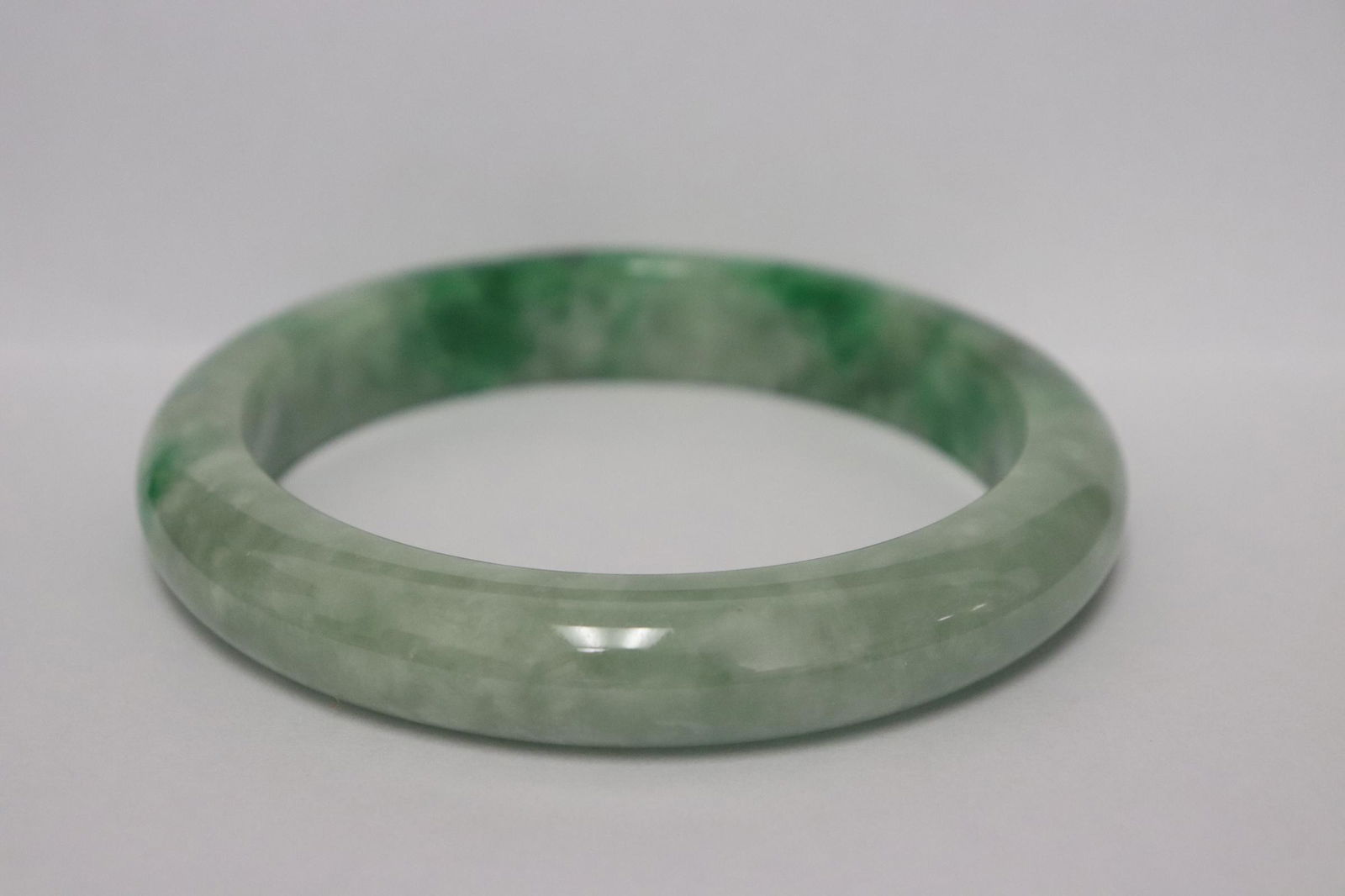 A large Chinese apple green jadeite bangle (1 of 8)
