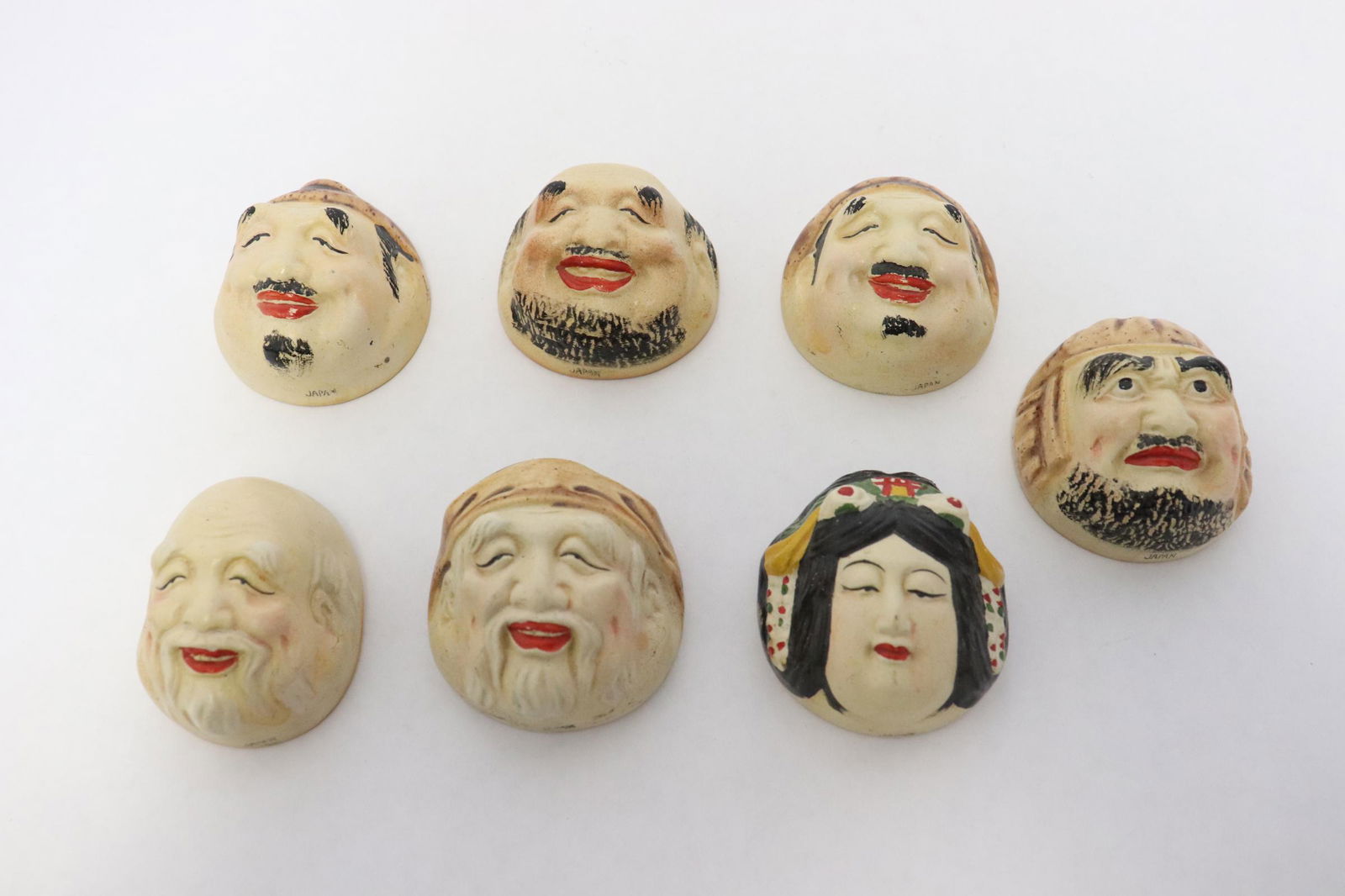 Very unusual 7 satsuma earthenware wine cups: Very unusual 7 satsuma earthenware wine cups in the form of heads, 2"H