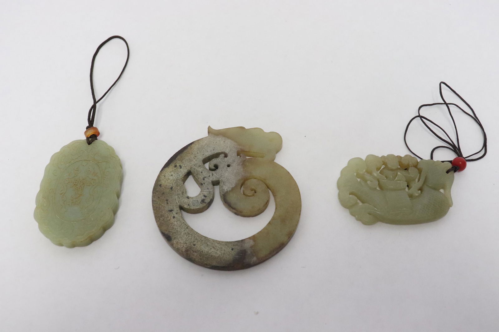 3 celadon jade carved ornaments: 3 celadon jade carved ornaments, 0.26"x1.6"x2.48" - 0.2"x3.45"x3.05"