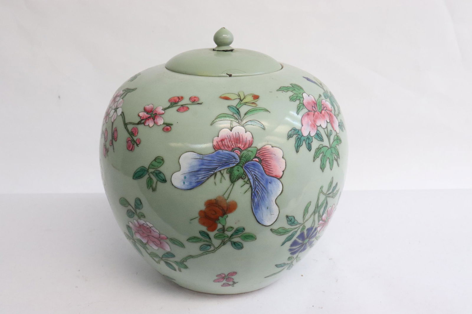 Chinese antique celadon famille rose porcelain jar: Chinese antique celadon famille rose porcelain jar with painted wood cover, hairline, 8.5"x8.2"dia
