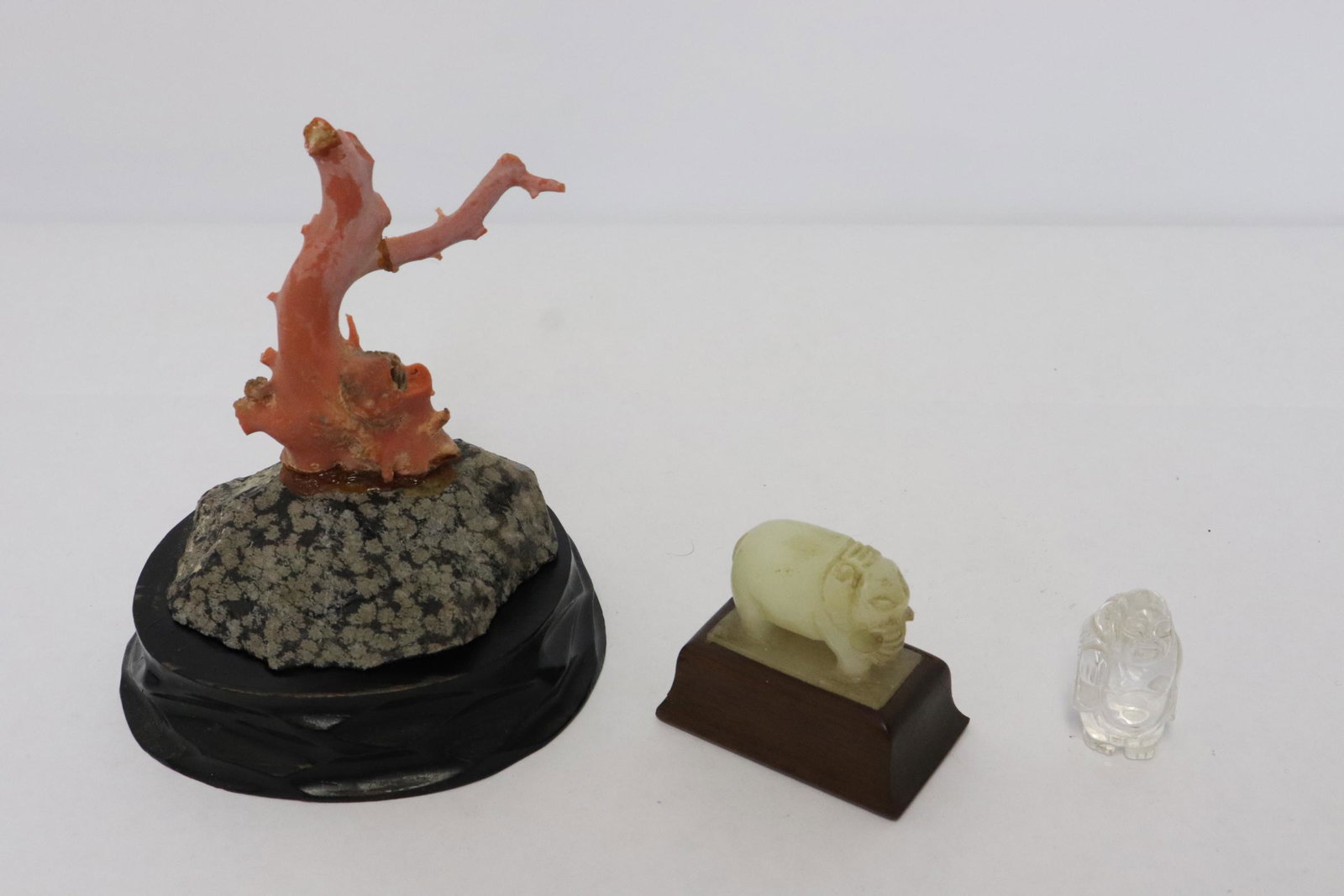 3 pieces: 3 pieces; a coral fragment (repair on branch arm) (3.1"H), a white jade carved elephant (1.2"H), and a crystal carved deity (1.45"H), NO INTERNATIONAL SHIPPING OF CORAL