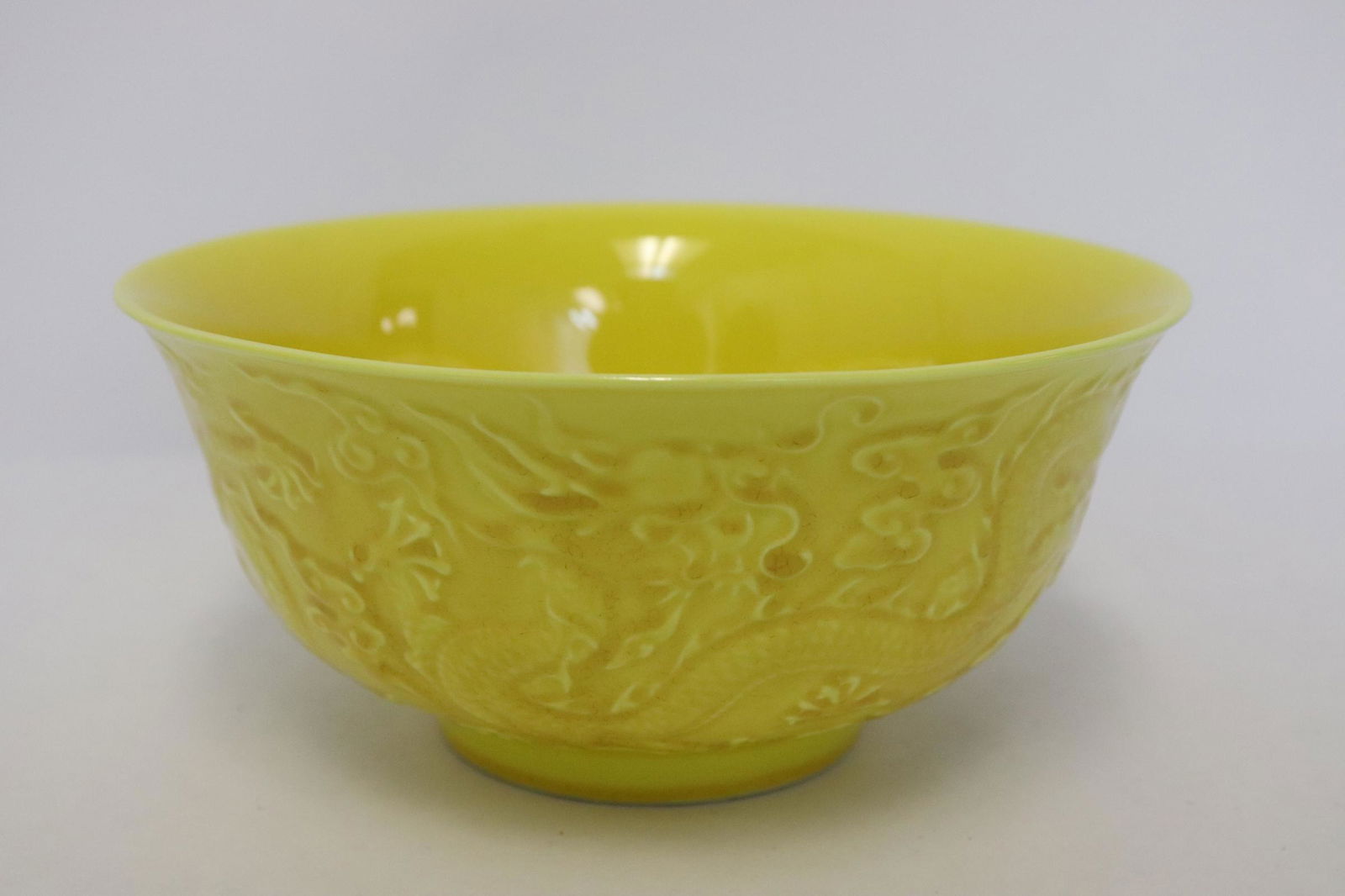 Chinese yellow glazed bowl: Chinese yellow glazed bowl embossed with dragon motif decoration, 2.9"x6.2"dia