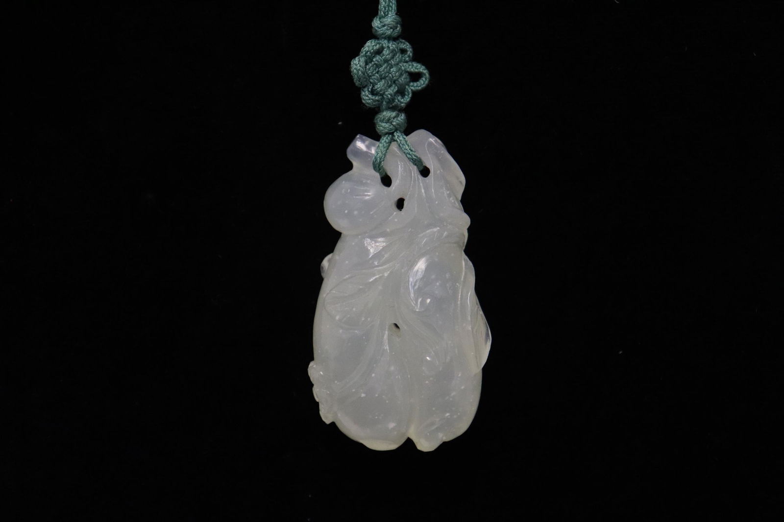 A highly translucent jadeite carving: A highly translucent jadeite carving depicting melon, 1.9"x1.05"x0.6"
