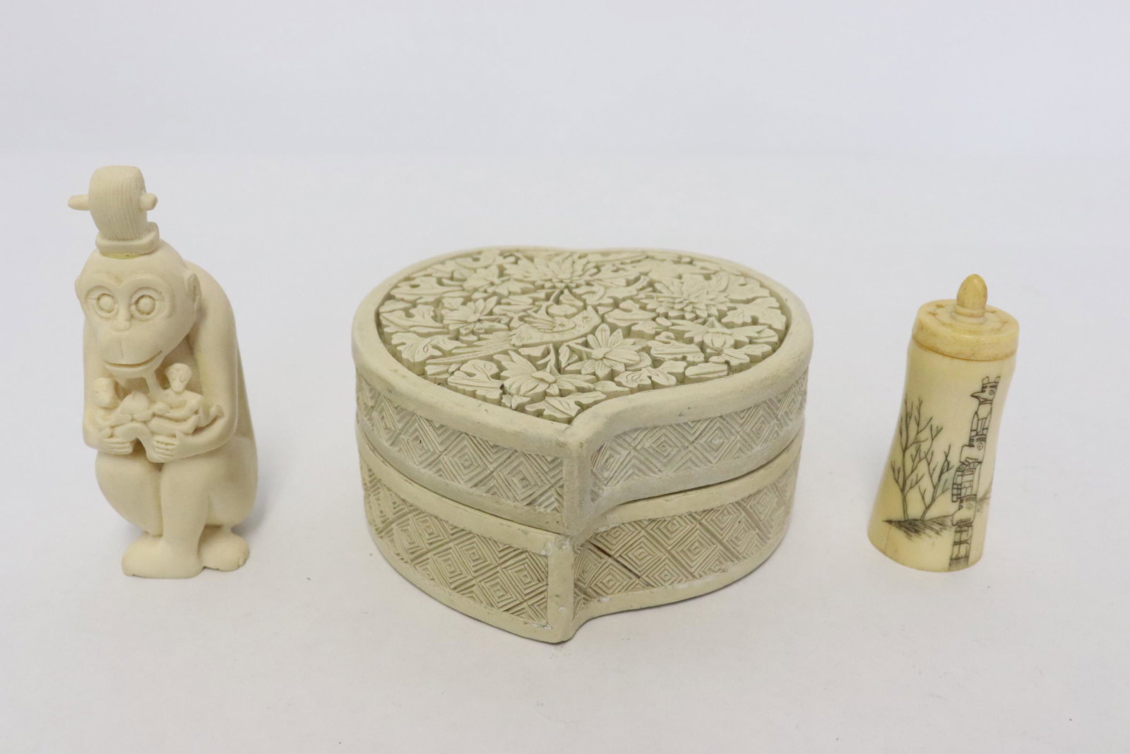 a bone bottle, a cinnabar box and a resin monkey: 3 pieces; a bone bottle (2.4"x1"dia), a cinnabar box (1.9"x3.7"x3.76") and a resin monkey (3.35"H)