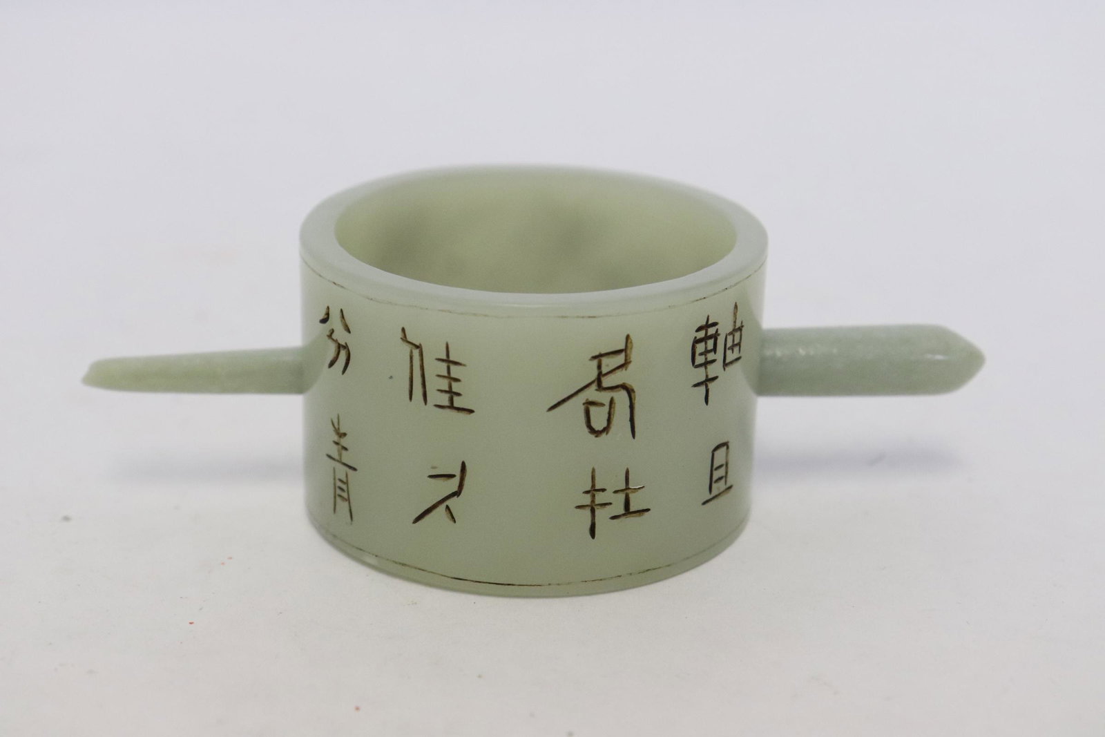 A light celadon jade carved ornament: A light celadon jade carved ornament, 1.16"x1.82"dia