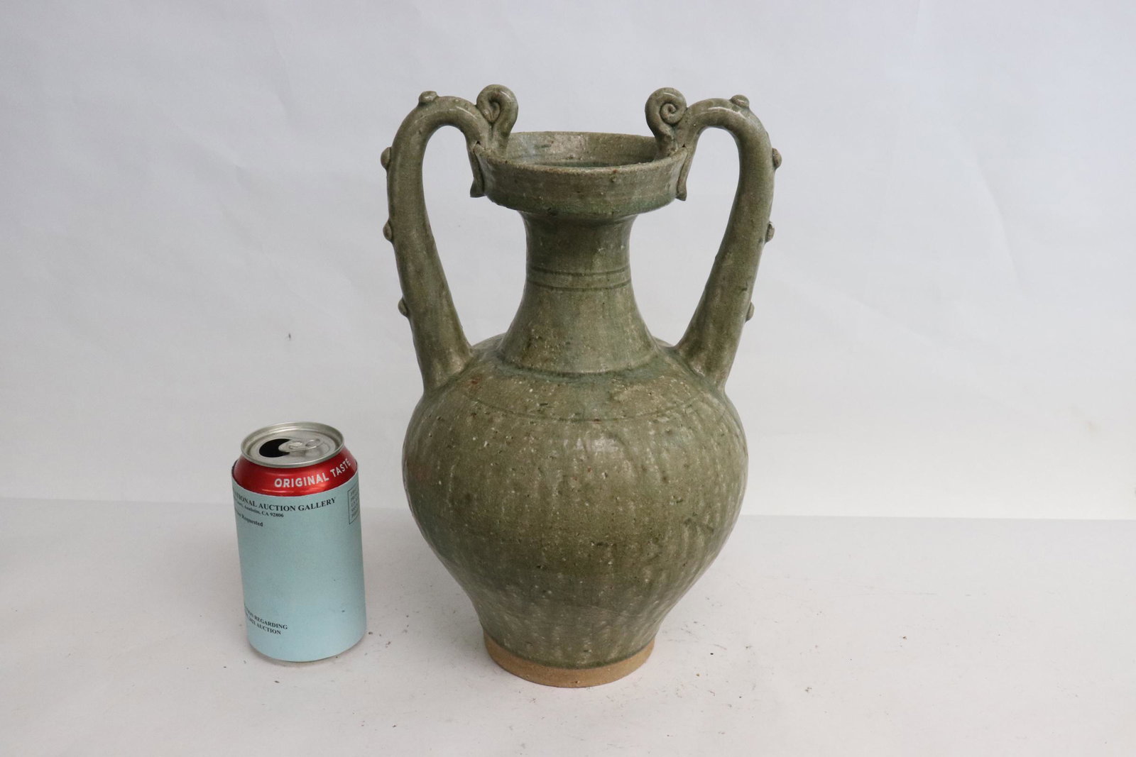 A green glazed earthenware handled vase (1 of 9)