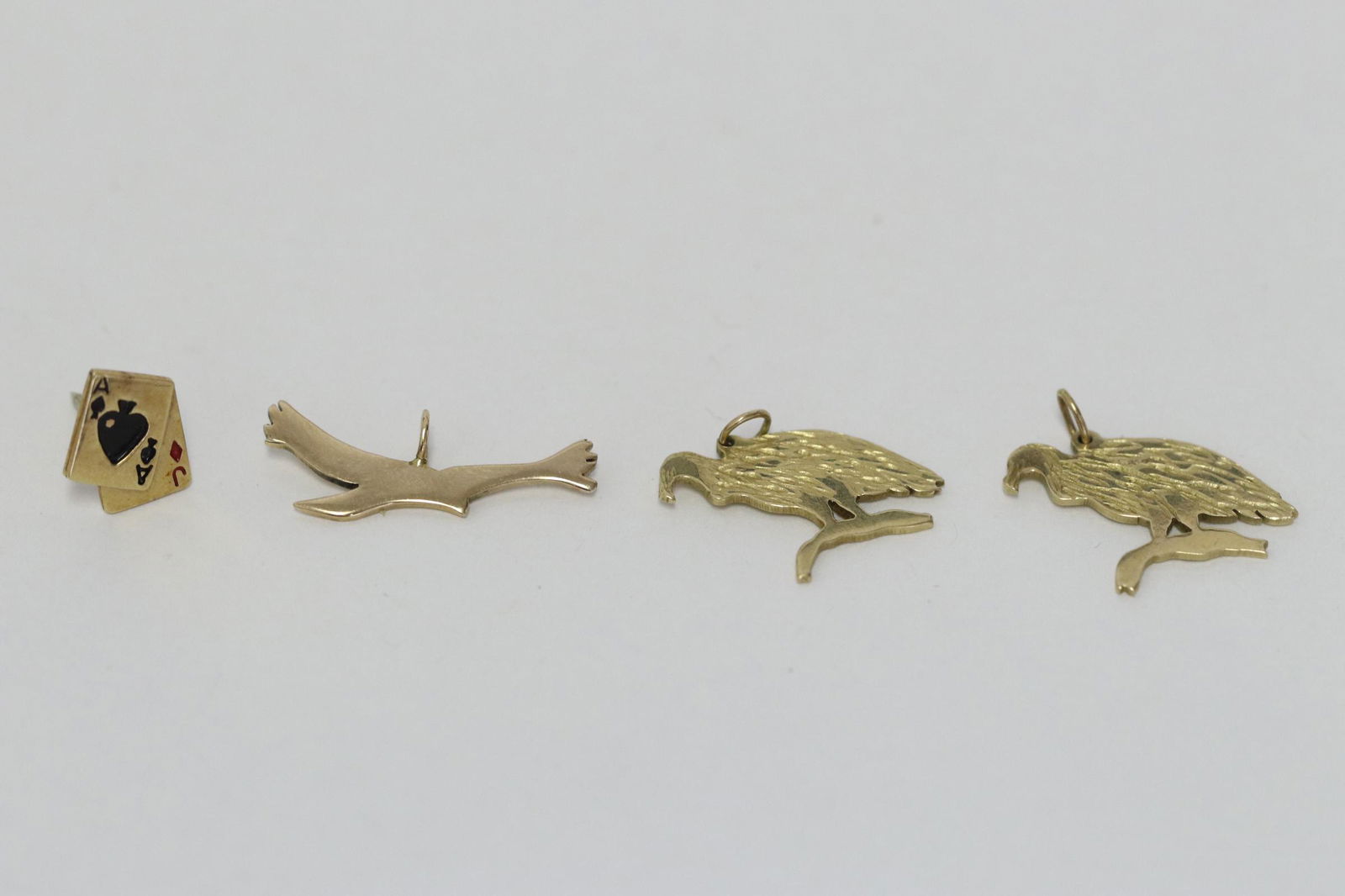 Three 14K pendants, and a 14K tie tack (1 of 9)