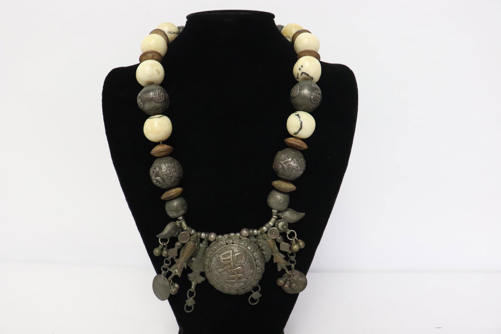 Necklace with various beads: Necklace with various beads; including 8 Japanese antique silver ogime beds, and finished with a silver plaque with "imperial" symbol in relief, 23.6"L
