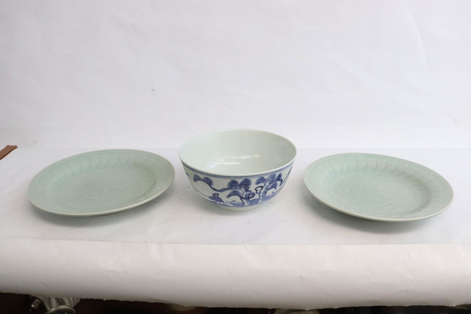 a b&w porcelain bowl, & 2 celadon porcelain plates: 3 pieces; a blue and white porcelain bowl (3.1"x6.35"dia), and 2 celadon porcelain plates (1.2"x8.2"dia)