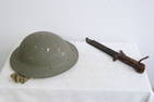 A British WWII helmet, and a vintage bayonet