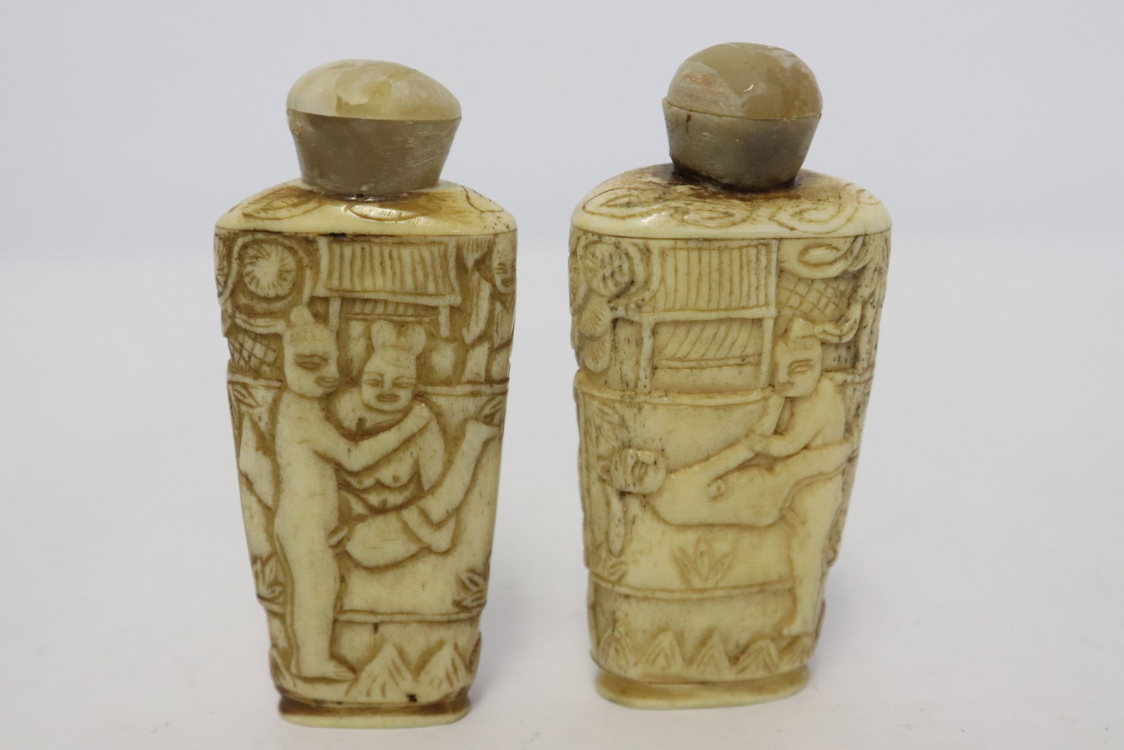2 Chinese bone carved snuff bottles: 2 Chinese bone carved snuff bottles, 2.85"x1.25"x0.8", 2.9"x1.35"x0.85"