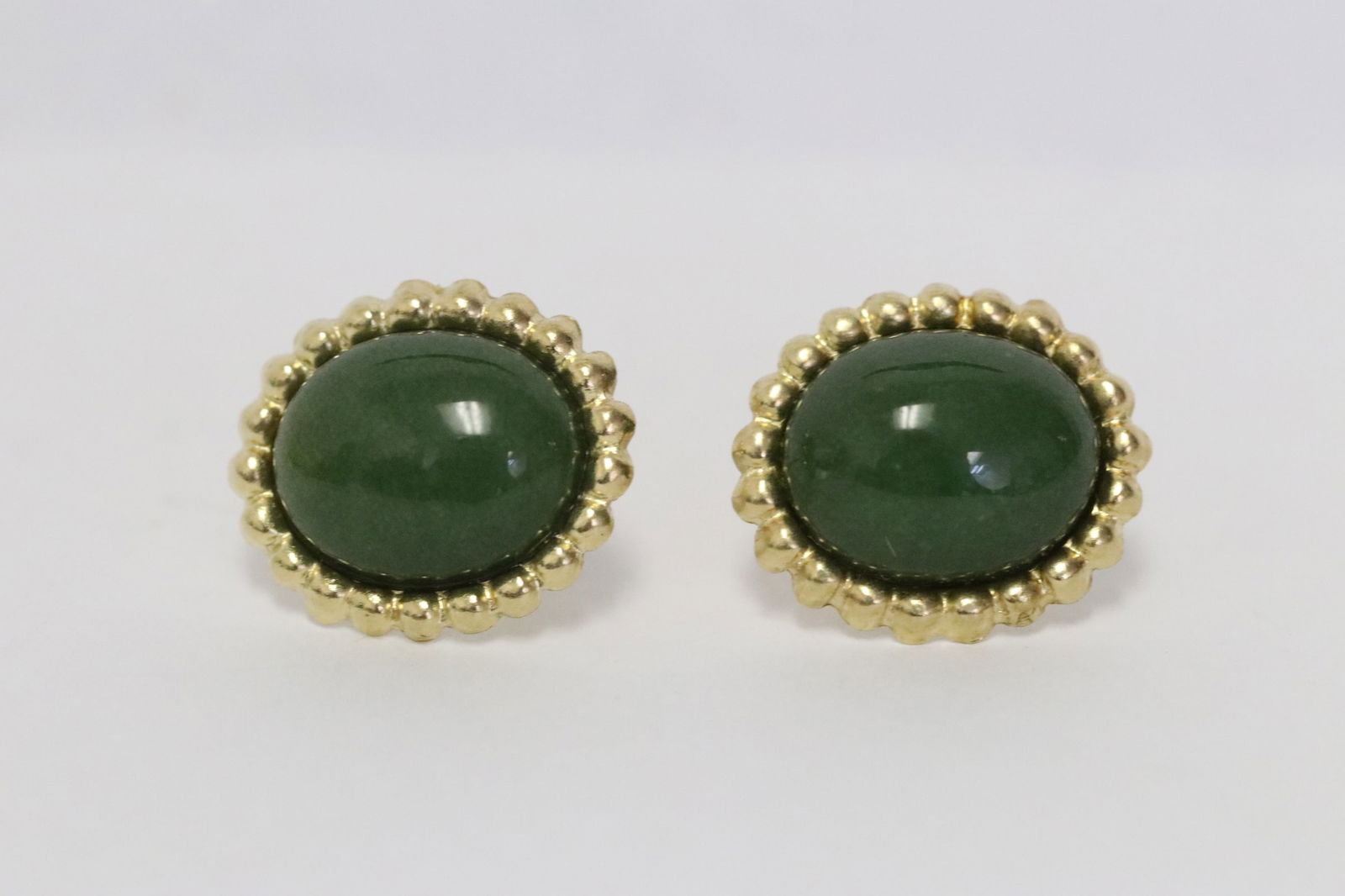 Pair 14K Y/G jadeite earrings: Pair 14K Y/G jadeite earrings, each jadeite measures approx. 10.3x8.5mm, wt. 1.5gm, no backs