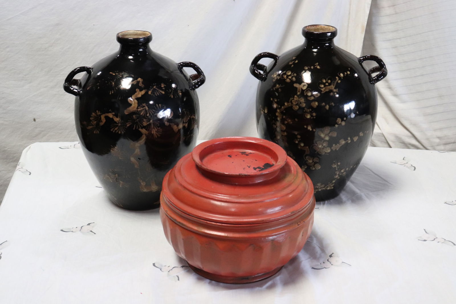 3 antique pieces: Pair antique Chinese/ Japanese earthenware wine jar (14.6"x11"x9.7"), and an antique red lacquer covered box (8.1"x11"dia)
