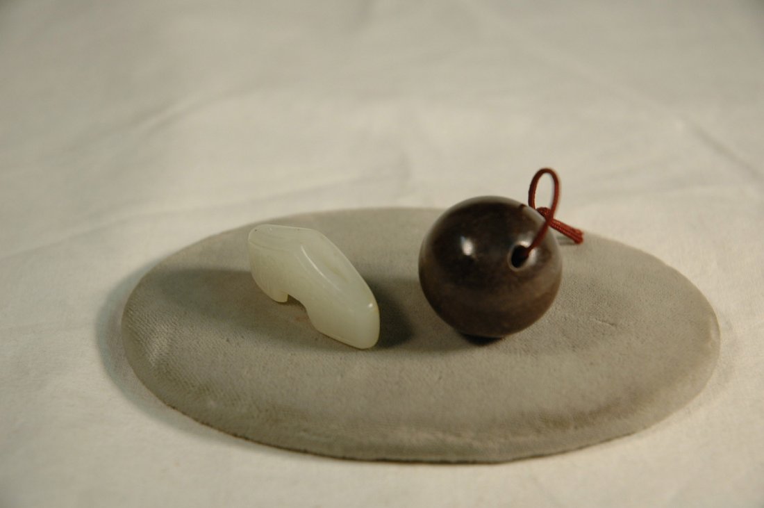 Chinese brown jade bead, & a white jade sword guard: Chinese bronze jade bead (0.98"diameter), and a white jade carved sword guard (0.59"Hx1.30"Wx0.28"D)