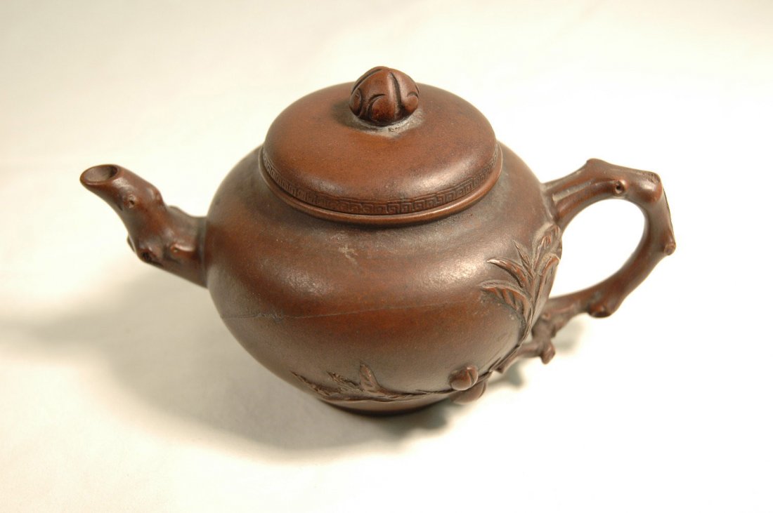 Chinese vintage Yixing clay teapot, signed: Chinese vintage Yixing clay teapot decorated with peach tree trunk and fruit in relief, maker's signature on bottom (3.46"Hx5.91"Wx3.54"D)