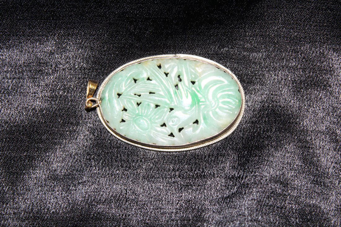 Chinese antique jadeite carved plaque: Chinese antique jadeite carved plaque depicting flowers in reticulate style with silver border (1,5"Hx1"W)