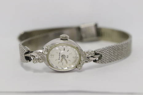 14K W/G lady's Bulova wrist watch w/ diamonds: 14K W/G lady's Bulova wrist watch set with small diamonds, band is gold filled, wt. 39gm