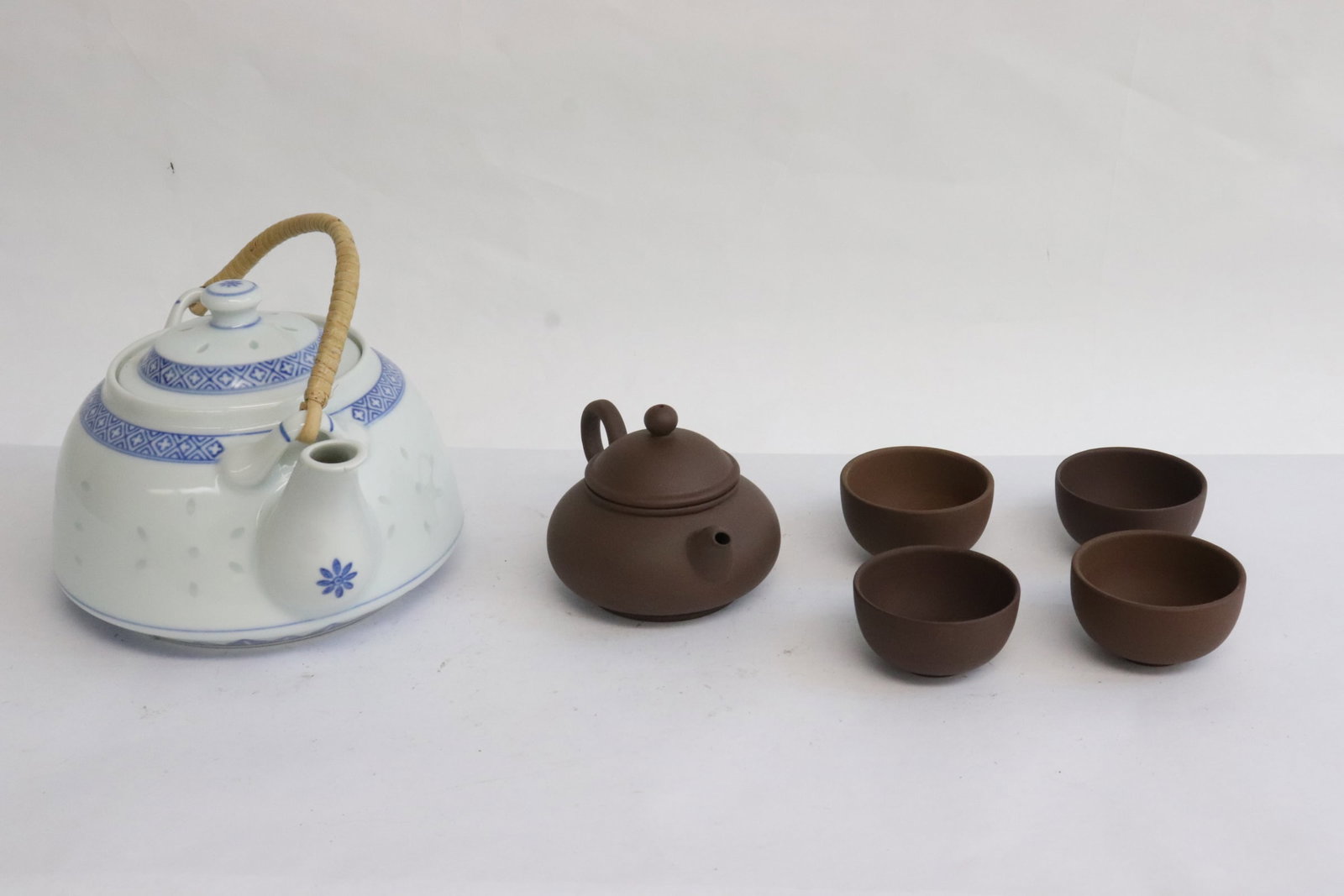 Blue and white teapot, and 5 piece Yixing tea set: Blue and white teapot (4.3"x7.1"x5.65"), and 5 piece Yixing tea set
