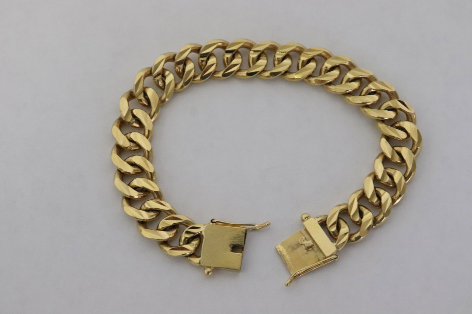A marked 75% (18K) Y/G flat link bracelet: A marked 75% (18K) Y/G flat link bracelet (6.8"L), wt. 44.4gm