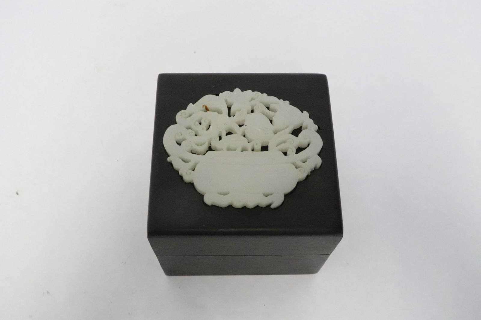 A wood box with white jade like stone on top (1 of 6)