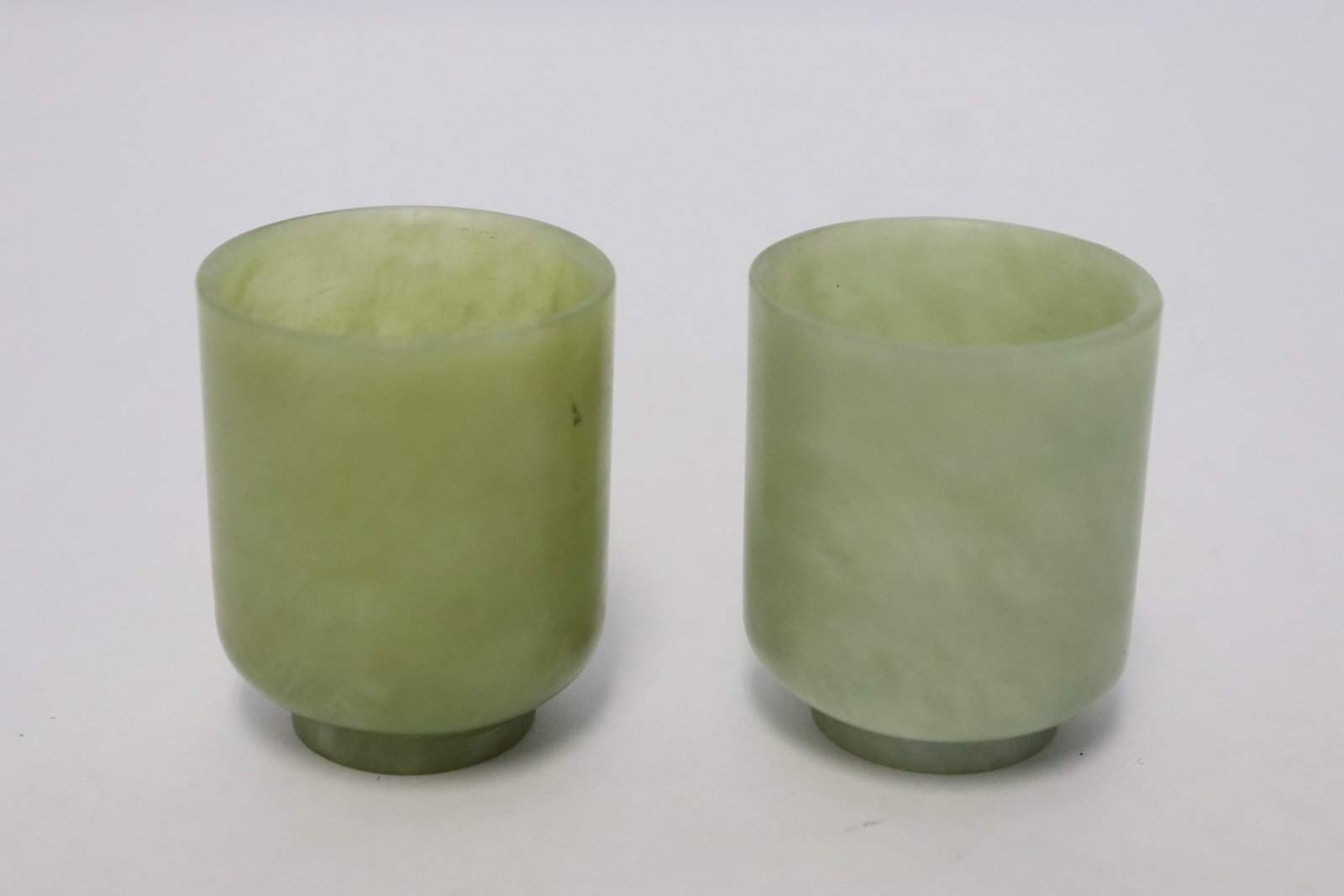 2 Chinese jade carved wine cups: 2 Chinese jade carved wine cups, 1.7"x1.35"dia