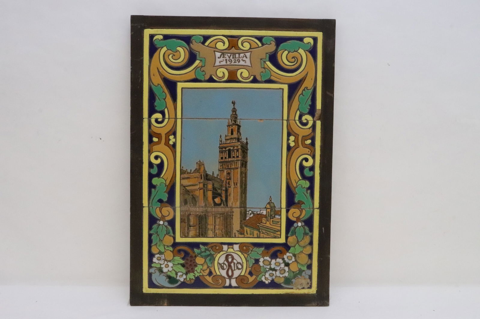 Framed majolica tiles, date 1929: Framed majolica tiles to depict city building, date 1929, small chip on side, 16.3"x10.8"