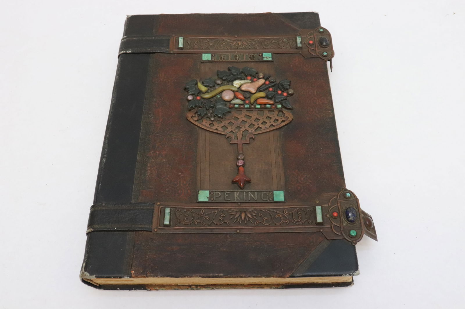 Chinese antique leather bond book w/ copper plaque: Rare Chinese antique leather bond book with hand tool copper plaque to depict "Peking" and longevity symbol, also set with tourmaline, jadeite, agate, coral, turquoise and other stones, inside are wri